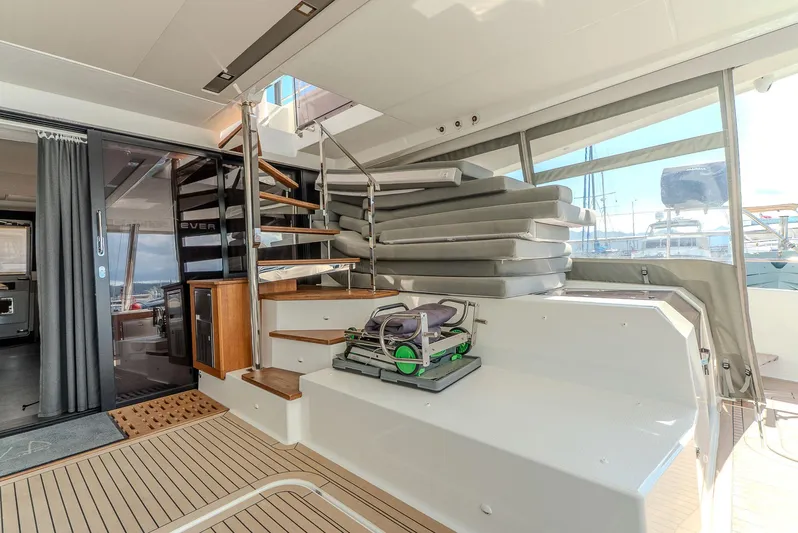  Yacht Photos Pics Luxurious 2022 Fountaine Pajot Samana 59 yacht interior with modern staircase and seating area.
