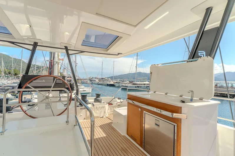  Yacht Photos Pics 2022 Fountaine Pajot Samana 59 yacht deck with helm and outdoor kitchen.