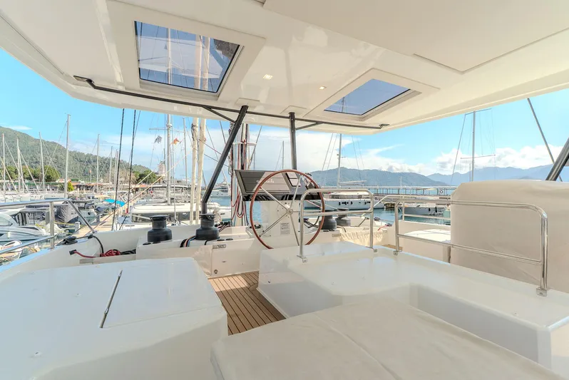  Yacht Photos Pics Luxurious 2022 Fountaine Pajot Samana 59 yacht interior with steering wheel and panoramic views.
