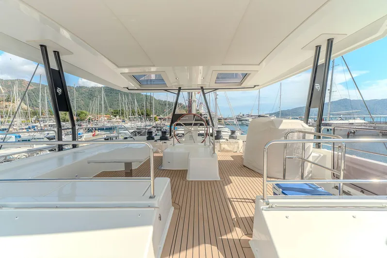  Yacht Photos Pics Spacious deck of 2022 Fountaine Pajot Samana 59 yacht in marina setting.