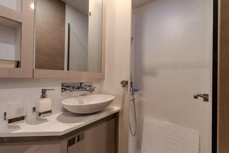  Yacht Photos Pics Modern bathroom interior on 2022 Fountaine Pajot Samana 59 yacht, featuring sleek sink and shower.