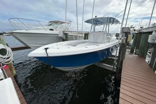  Yacht Photos Pics 2023 Contender 28 Tournament boat docked, featuring sleek blue hull design.
