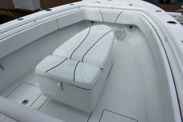  Yacht Photos Pics 2023 Contender 28 Tournament boat interior with white cushioned seating.