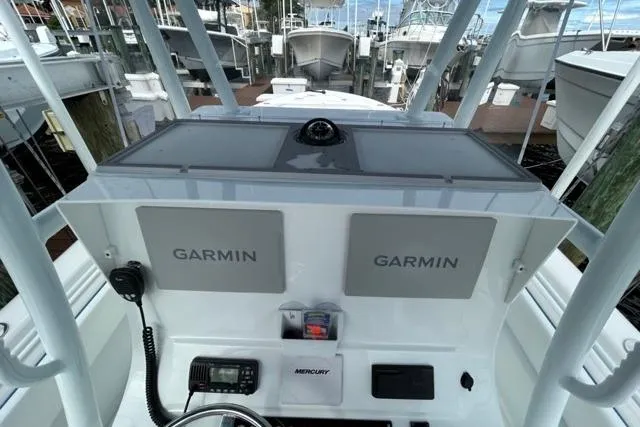  Yacht Photos Pics 2023 Contender 28 Tournament boat dashboard with Garmin navigation systems at a marina.