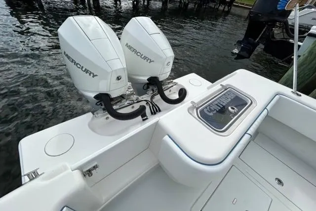  Yacht Photos Pics 2023 Contender 28 Tournament boat with dual Mercury engines, docked by the water.