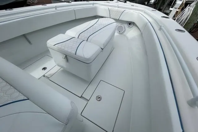  Yacht Photos Pics 2023 Contender 28 Tournament boat interior with cushioned seating and storage compartments.