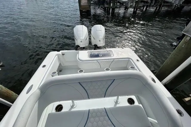  Yacht Photos Pics 2023 Contender 28 Tournament boat with dual engines, docked on calm water.