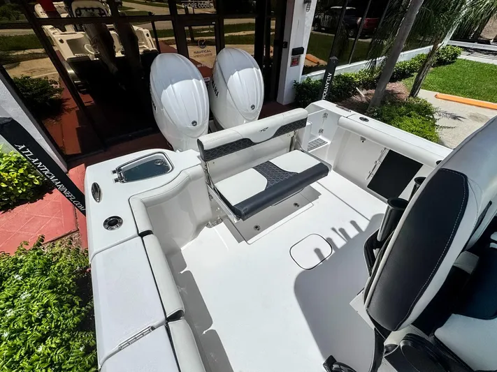  Yacht Photos Pics 2024 Tidewater 256 Adventurer boat interior with seating and dual engines.