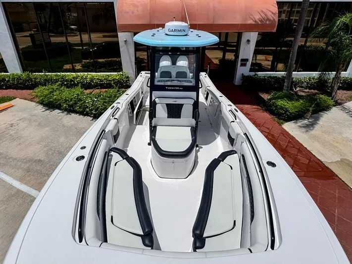  Yacht Photos Pics 2024 Tidewater 256 Adventurer boat with spacious seating and Garmin equipment, docked outdoors.