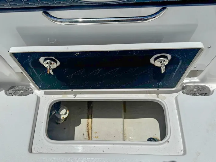  Yacht Photos Pics Open storage compartment on 2024 Tidewater 256 Adventurer boat, featuring secure latches and spacious interior.