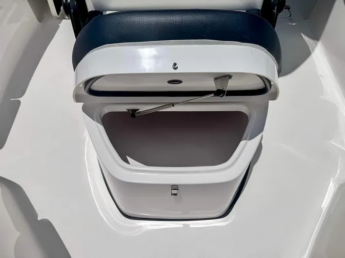  Yacht Photos Pics 2024 Tidewater 256 Adventurer boat seat with open storage compartment.