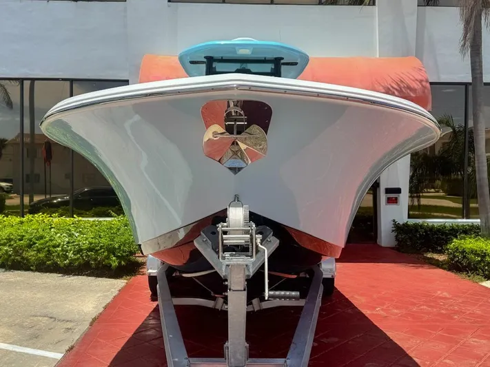  Yacht Photos Pics 2024 Tidewater 256 Adventurer boat on trailer, front view, outdoors.