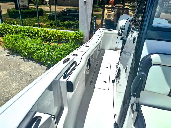  Yacht Photos Pics 2024 Tidewater 256 Adventurer boat interior with sleek white seating and modern design.