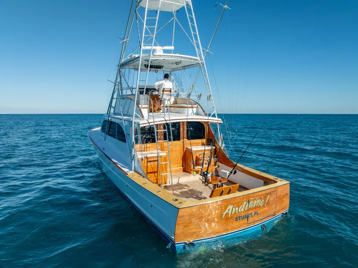 Andiamo Yacht Photos Pics 1979 Merritt 46 yacht on open sea, featuring fishing equipment and tower.