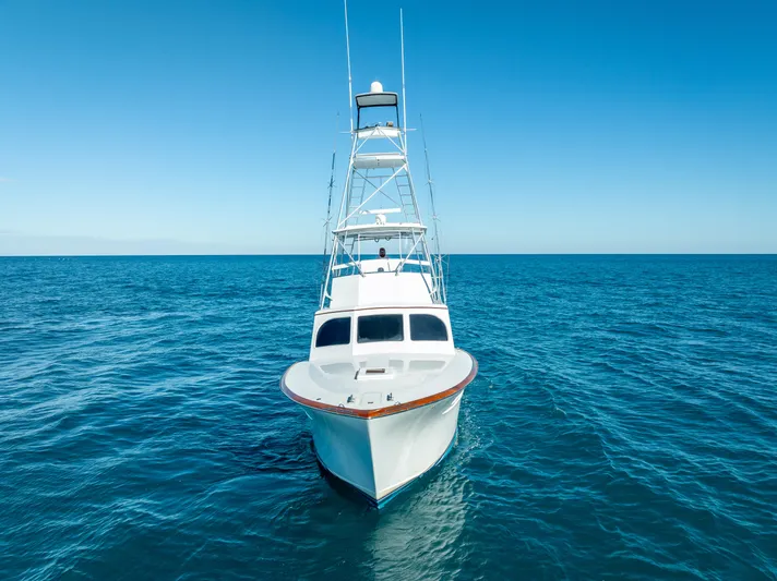 Andiamo Yacht Photos Pics 1979 Merritt 46 boat on open sea under clear blue sky.