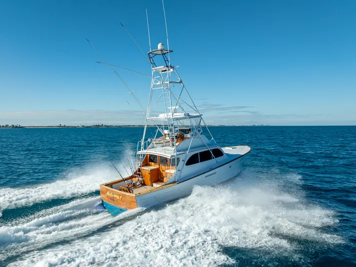 Andiamo Yacht Photos Pics 1979 Merritt 46 yacht cruising on open sea under clear blue sky.
