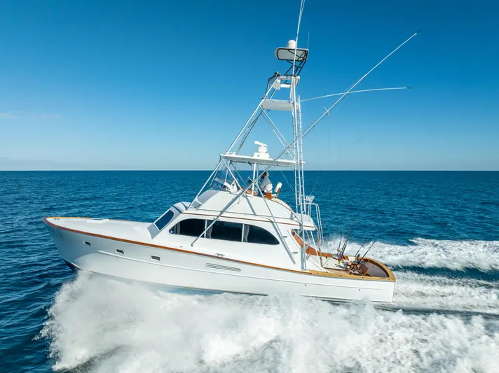 Andiamo Yacht Photos Pics 1979 Merritt 46 yacht cruising on open sea under clear blue sky.