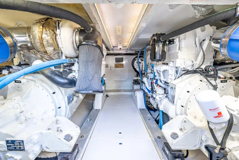 Andiamo Yacht Photos Pics Engine room of a 1979 Merritt 46 boat, showcasing dual engines and mechanical components.