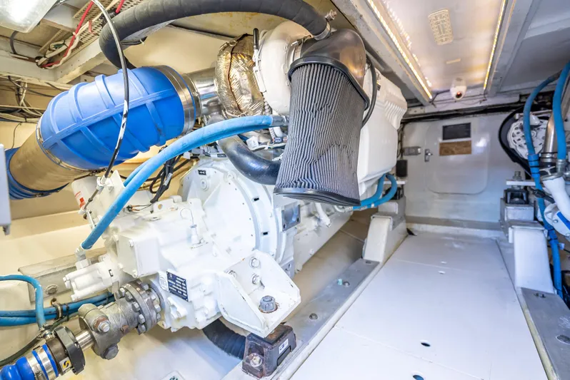 Andiamo Yacht Photos Pics Engine room of a 1979 Merritt 46 boat, showcasing mechanical components and piping.