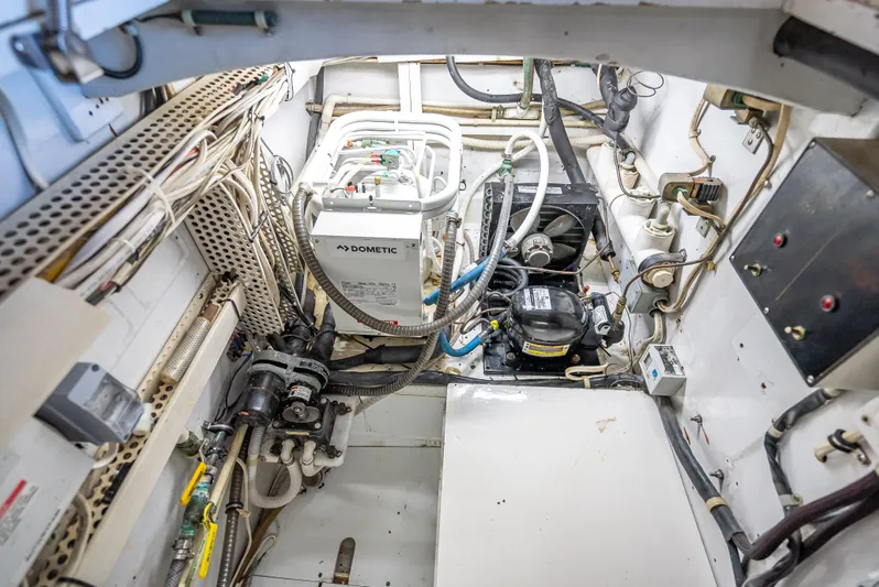 Andiamo Yacht Photos Pics Engine room of a 1979 Merritt 46 boat, featuring various mechanical components and wiring.