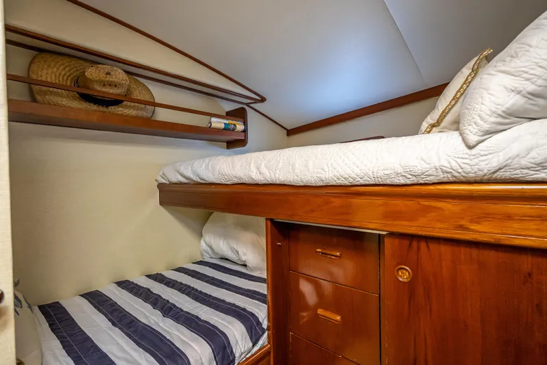 Andiamo Yacht Photos Pics Cozy 1979 Merritt 46 yacht cabin with bunk beds and wooden storage.