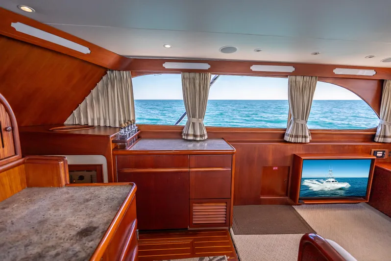 Andiamo Yacht Photos Pics Luxurious 1979 Merritt 46 yacht interior with ocean view and elegant wood finishes.