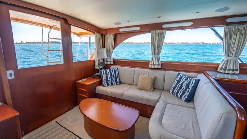 Andiamo Yacht Photos Pics Interior of 1979 Merritt 46 yacht with cozy seating and ocean view.