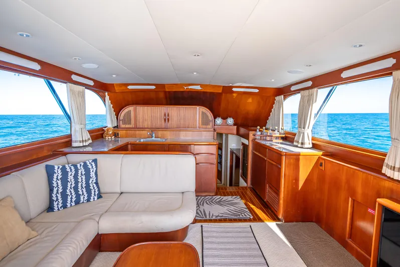 Andiamo Yacht Photos Pics Luxurious 1979 Merritt 46 yacht interior with elegant wood finishes and ocean view.