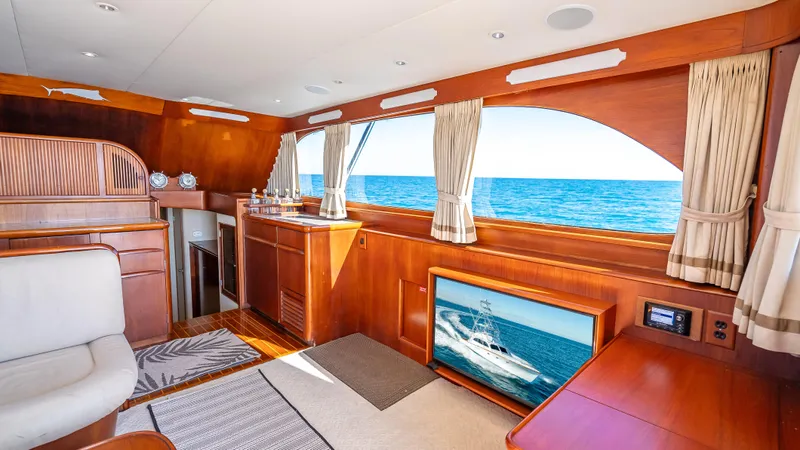 Andiamo Yacht Photos Pics Luxurious 1979 Merritt 46 yacht interior with ocean view, featuring elegant wood finishes and modern amenities.