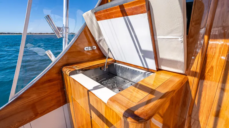 Andiamo Yacht Photos Pics Wooden deck with sink on 1979 Merritt 46 boat, overlooking blue ocean.