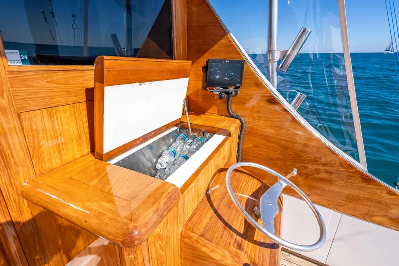 Andiamo Yacht Photos Pics Wooden helm station on 1979 Merritt 46 yacht with cooler and steering wheel.