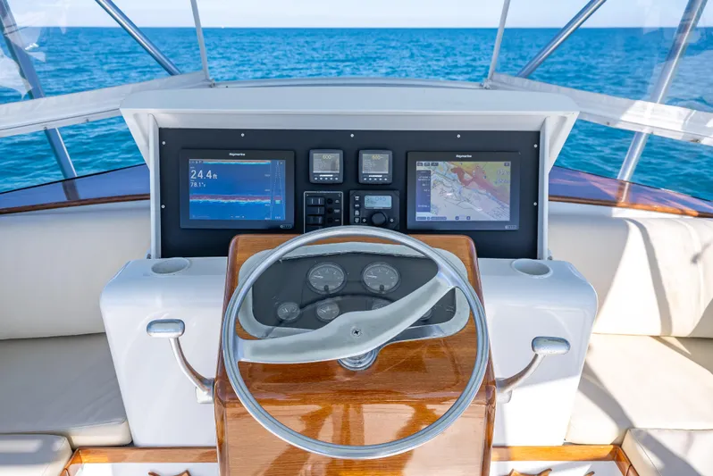 Andiamo Yacht Photos Pics Helm of 1979 Merritt 46 yacht with modern navigation displays, ocean view.