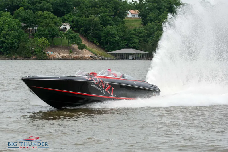  Yacht Photos Pics 2009 Donzi 38 ZRC speedboat cruising on a lake with water spray.