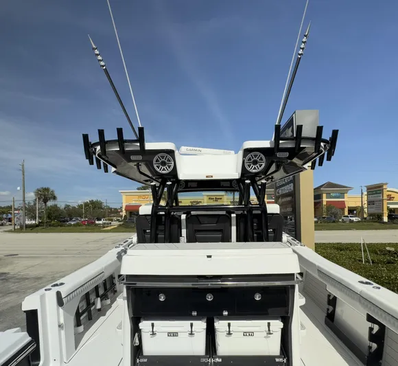 400-102 Yacht Photos Pics 2024 Blackfin 400 CC boat with fishing rod holders and storage, parked outdoors.