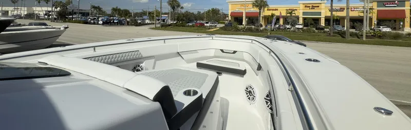 400-102 Yacht Photos Pics 2024 Blackfin 400 CC boat interior with seating and speakers, parked near shops.