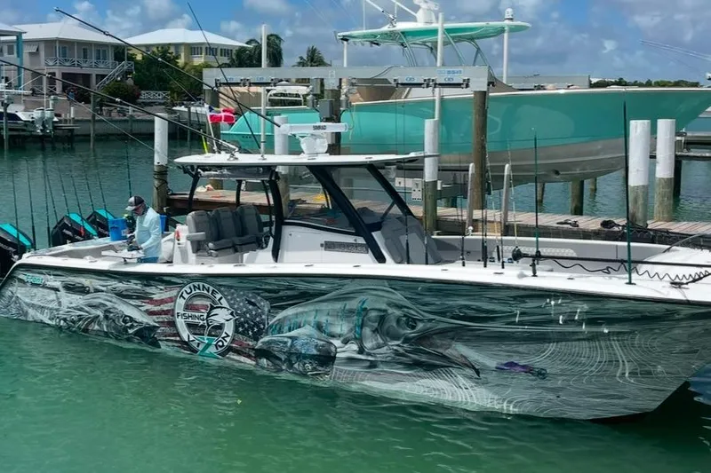  Yacht Photos Pics 2024 Front Runner 37 Catamaran with vibrant fishing-themed hull design docked at marina.