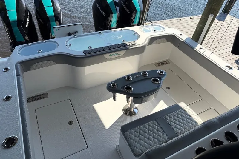  Yacht Photos Pics 2024 Front Runner 37 Catamaran cockpit with seating and rod holders, docked by the water.