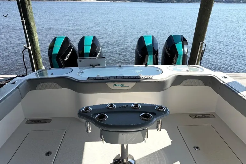  Yacht Photos Pics 2024 Front Runner 37 Catamaran with four Mercury outboard engines, docked by the water.