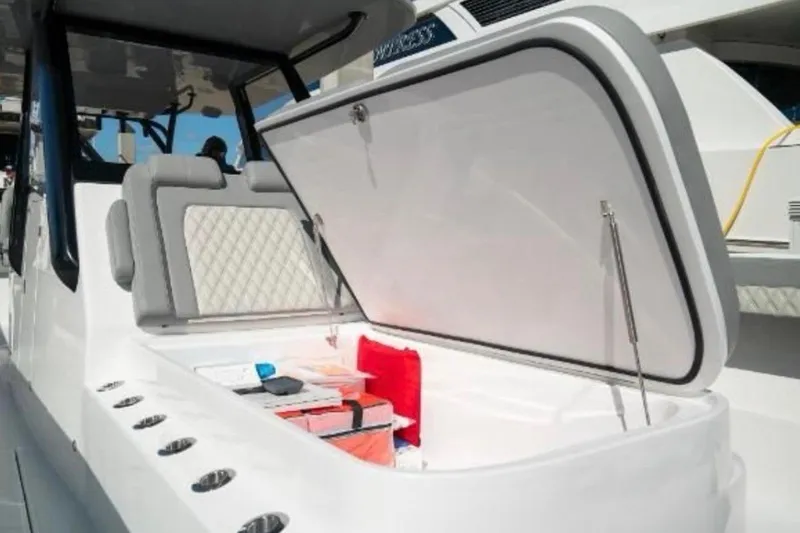  Yacht Photos Pics 2024 Front Runner 37 Catamaran with open storage compartment and cushioned seating.