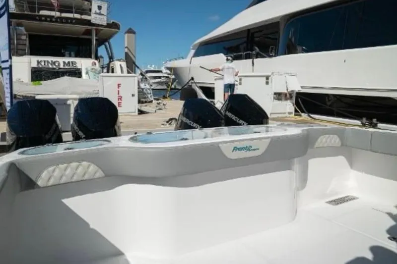  Yacht Photos Pics 2024 Front Runner 37 Catamaran at marina with Mercury engines, docked beside luxury yachts.