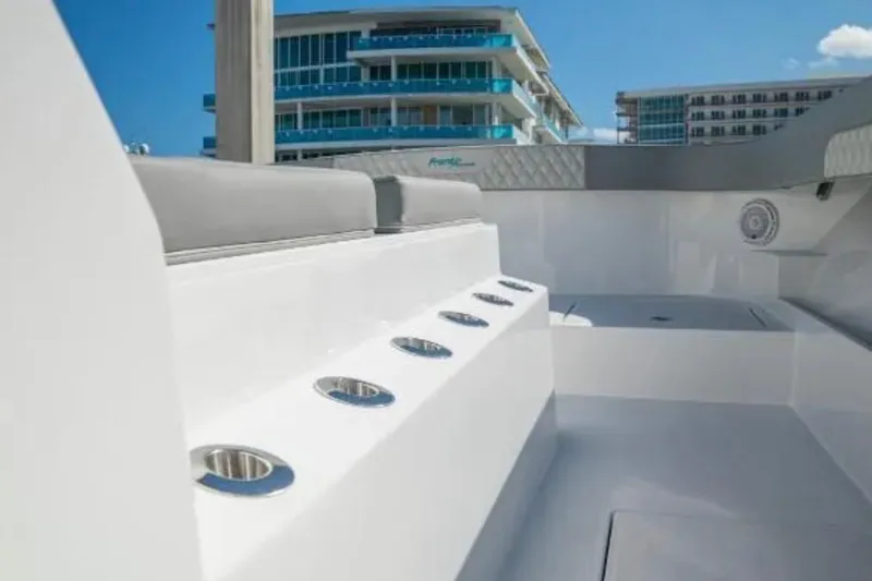  Yacht Photos Pics 2024 Front Runner 37 Catamaran interior with modern seating and cup holders, docked near buildings.