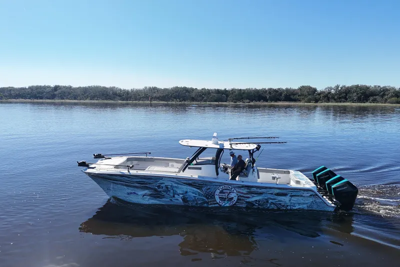  Yacht Photos Pics 2024 Front Runner 37 Catamaran cruising on calm water under clear blue sky.