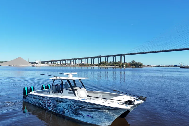  Yacht Photos Pics 2024 Front Runner 37 Catamaran on a river with a bridge in the background.