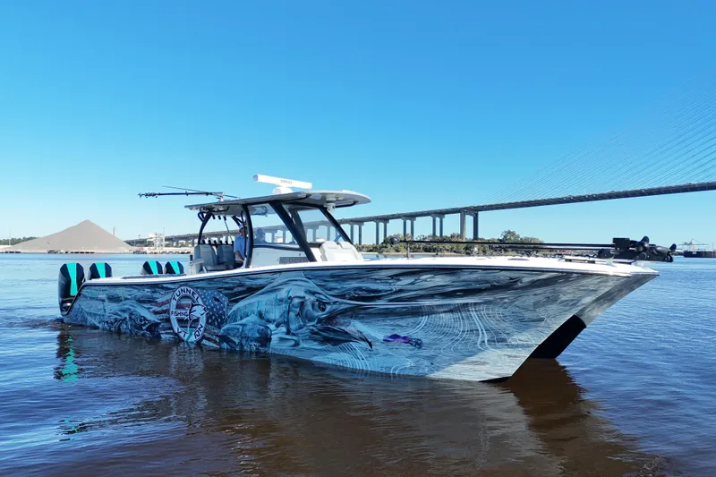  Yacht Photos Pics 2024 Front Runner 37 Catamaran with custom graphics on a calm river.