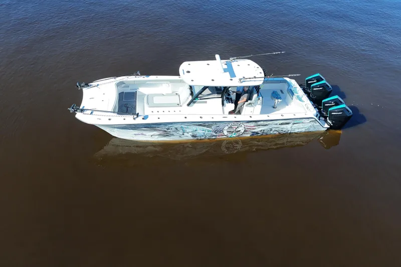  Yacht Photos Pics 2024 Front Runner 37 Catamaran on calm water, featuring twin outboard engines.