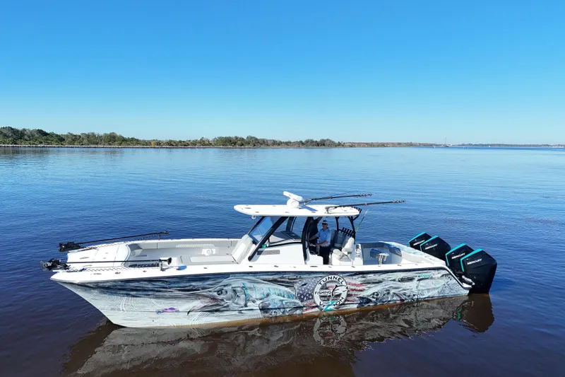  Yacht Photos Pics 2024 Front Runner 37 Catamaran on calm water, featuring vibrant marine artwork.