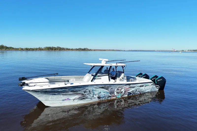  Yacht Photos Pics 2024 Front Runner 37 Catamaran on calm water, featuring vibrant marine graphics.