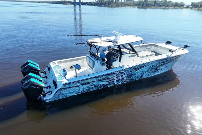  Yacht Photos Pics 2024 Front Runner 37 Catamaran on calm water, featuring vibrant graphics and powerful Mercury engines.