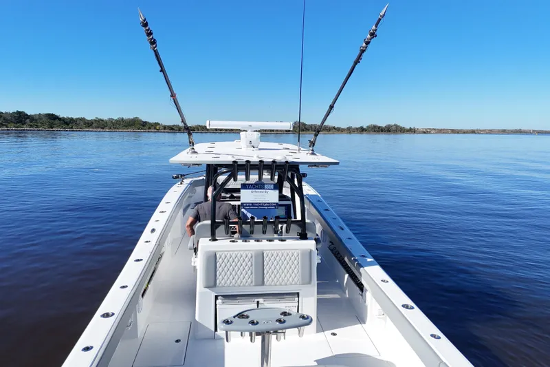  Yacht Photos Pics 2024 Front Runner 37 Catamaran on calm water, featuring fishing rods and spacious deck.