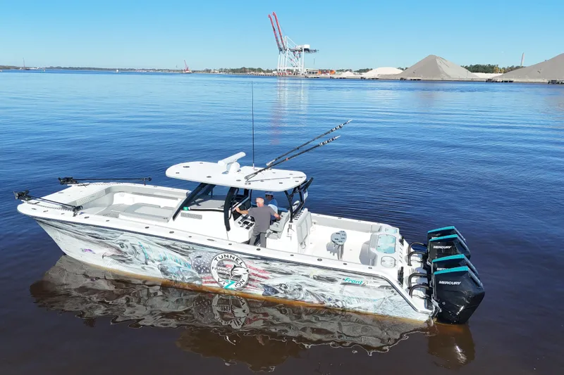  Yacht Photos Pics 2024 Front Runner 37 Catamaran on calm water, featuring vibrant graphics and powerful Mercury engines.